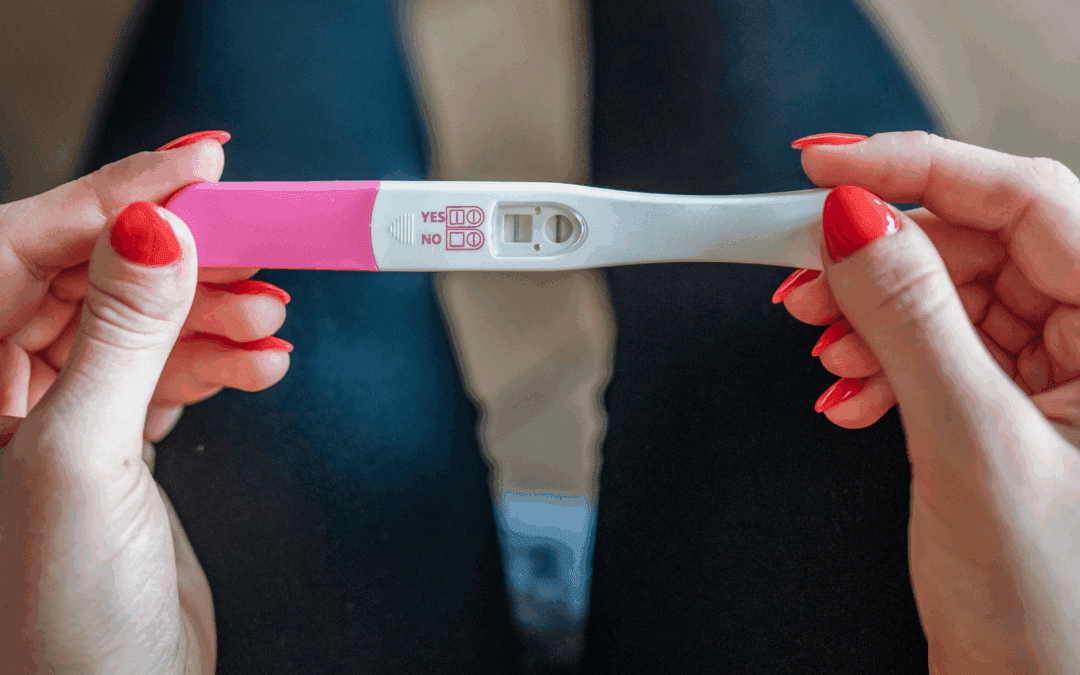 woman holding positive pregnancy test