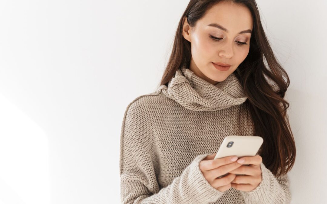 woman on phone looking at information about sex after abortion